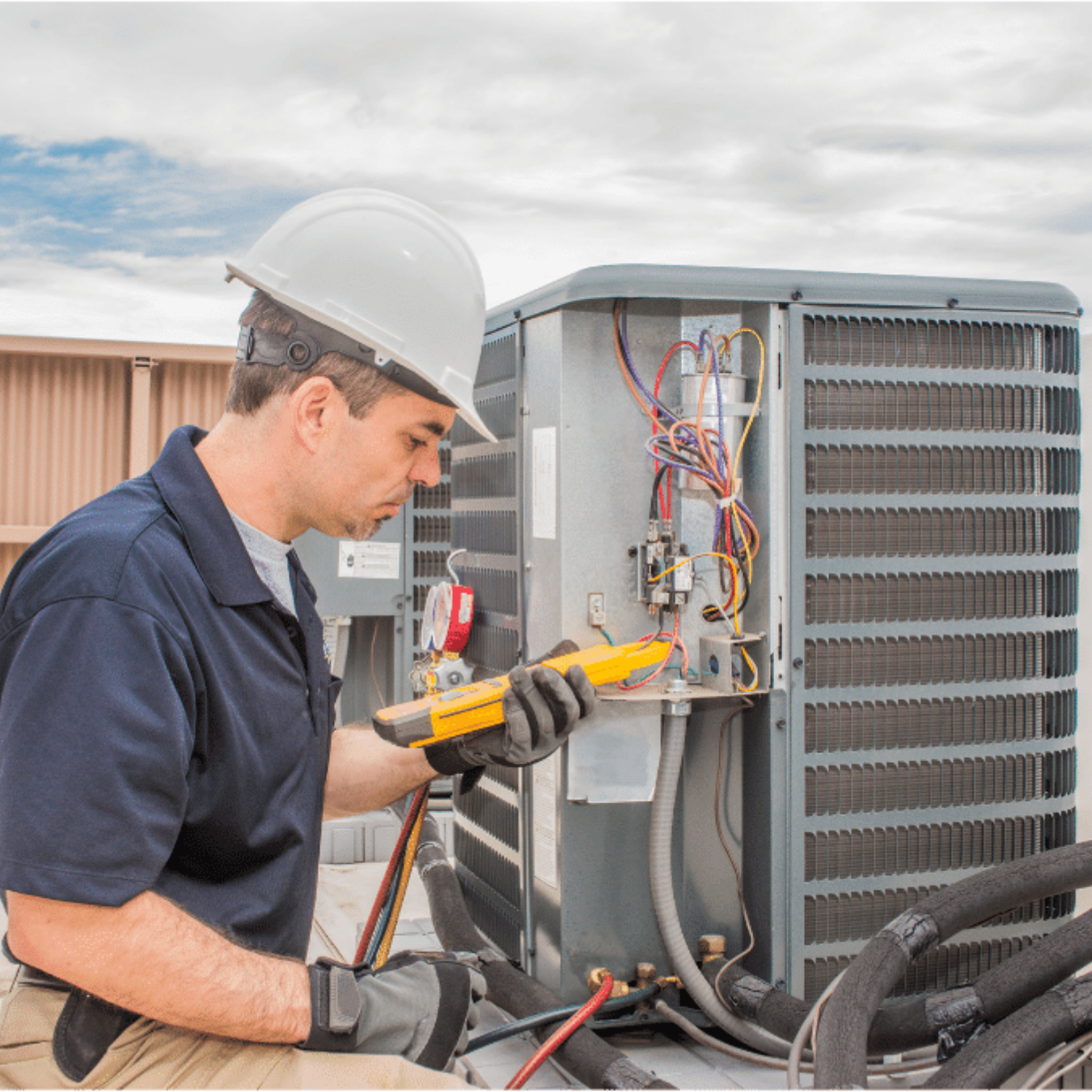 Ajax Heating & Cooling HVAC technician servicing a system