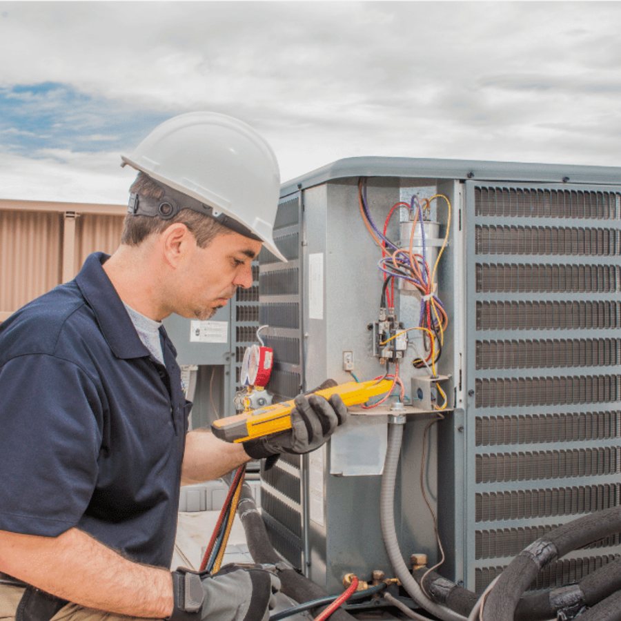 Ajax Heating & Cooling HVAC technician servicing a system